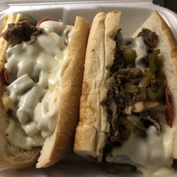 two sandwiches in a styrofoam container two sandwiches in a styrofoam container