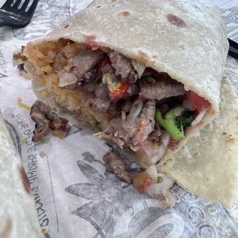 Cotija's Cocina Mexicana - Surf and Surf & Turf Burrito cut in half. - Mexican Near Me - San Diego, California Cotija's Cocina Mexicana - Surf and Surf & Turf Burrito cut in half. - Mexican Near Me - San Diego, California