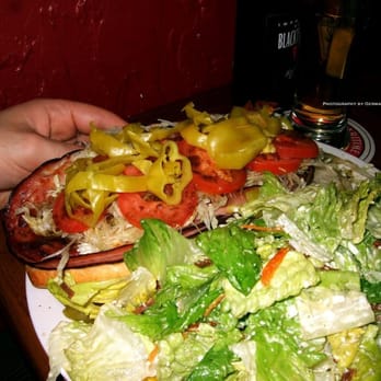 Jolly Roger Taproom - Hot Italian sandwich with salami, Provolone + ham, served with a Caesar salad on the side. - Brewpubs Near Me - Seattle, Washington