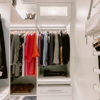 California Closets - Burnaby - Walk-in closet with custom lighting and a wall-mounted organizer - California Closets in Burnaby, BC - Interior Design Near Me - Burnaby, British Columbia California Closets - Burnaby - Walk-in closet with custom lighting and a wall-mounted organizer - California Closets in Burnaby, BC - Interior Design Near Me - Burnaby, British Columbia