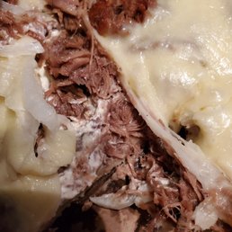 a piece of meat and cheese pizza