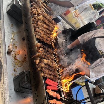 So Sarap NYC - a man cooking food on a grill - Filipino Near Me