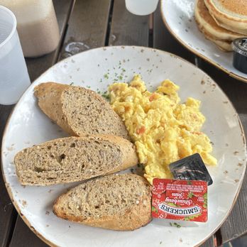 Crema Gourmet - feta and tomato scrambled eggs with multigrain bread and jam - Coffee & Tea Near Me - Coral Gables, Florida Crema Gourmet - feta and tomato scrambled eggs with multigrain bread and jam - Coffee & Tea Near Me - Coral Gables, Florida