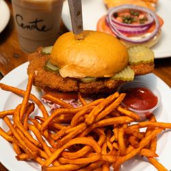 Cenote - Fried Chicken Breast, House Made Hot Honey, Creamy Verde Mayo, Pickles, Tomato & Slaw on an Artisan Bun. Served with Fries