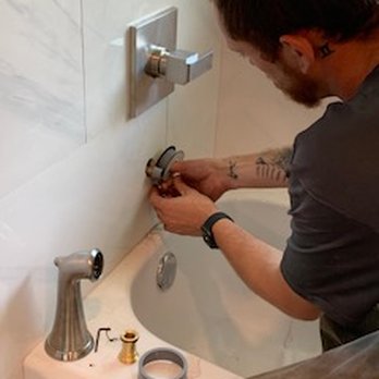 Plumbtastic Solutions - a man fixing a faucet in a bathroom - Plumbing Near Me - Edmond, Oklahoma Plumbtastic Solutions - a man fixing a faucet in a bathroom - Plumbing Near Me - Edmond, Oklahoma