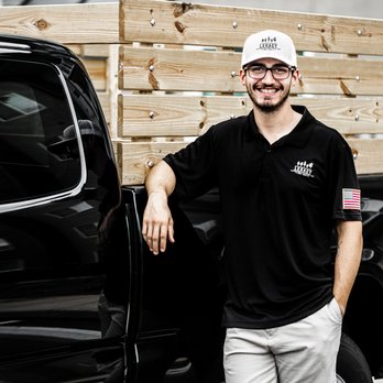 Legacy Landscape Solutions - a man standing in front of a truck - Lawn Services Near Me Legacy Landscape Solutions - a man standing in front of a truck - Lawn Services Near Me