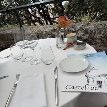 Grimaldi Palais - Outside table setting at Castelroc restaurant... we saw the changing of the guards at the palace, then had a delicious lunch here. - Landmarks & Historical Buildings Near Me - Monaco, 01