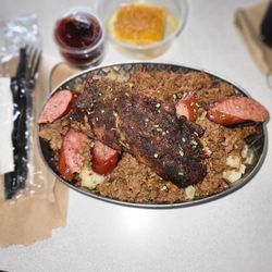 TaterQue - A bucket load of baked potato, topped with smoked sausage, ribs, chopped brisket, corn bread and BBQ sauce