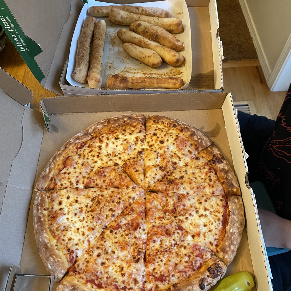 Cheese pizza with side of garlic breadsticks