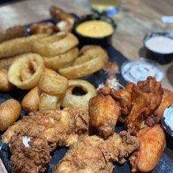 The Owners Box Sports Bar & Grill - Game day appetizer plate. Fried pickles, cheese sticks, onion rings, bone in wings and chicken tenders