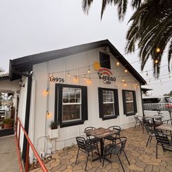 Verano Cafe - The front of Verano Café with some bistro tables