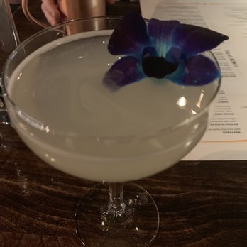 Cork and Rye - Gin tin tin and Moscow mule in the background. Edible Orchid on the gin tin tin. Must try beverages! - Gastropubs Near Me - Warwick, Rhode Island