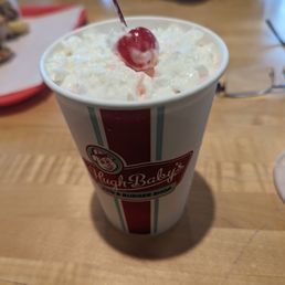a cup of milkshake with a cherry on top a cup of milkshake with a cherry on top