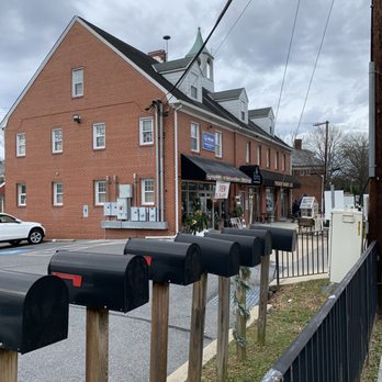 Passion Bakery Cafe - a row of mailboxes in front of a brick building - Bakeries Near Me - Ashton-Sandy Spring, Maryland