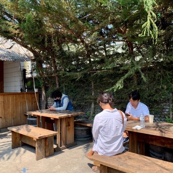 Okkon - two men sitting at picnic tables - Japanese Near Me - Oakland, California