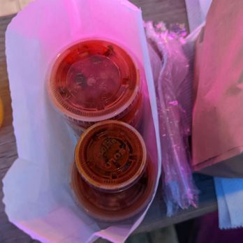 Taquitos - two cups of hot sauce on a picnic table - Mexican Near Me - Pittsburgh, Pennsylvania