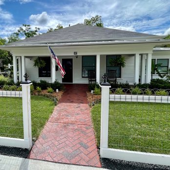 Texas Nativescapes - a white house with a flag on the front porch - Landscaping Near Me - Denton, Texas