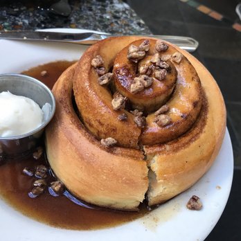 Cafe Flora - Cinnamon Roll (with an over zealous knife cut) - Vegetarian Near Me - Seattle, Washington