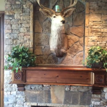St Marlo Country Club - The fireplace and decorated stag. - Golf Near Me - Duluth, Georgia