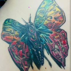 Agaru Tattoo & Body Piercing - Supposed to be a badass biomechanical moth & rainbow vibes. Instead, it looks like the moth went through a midlife crisis