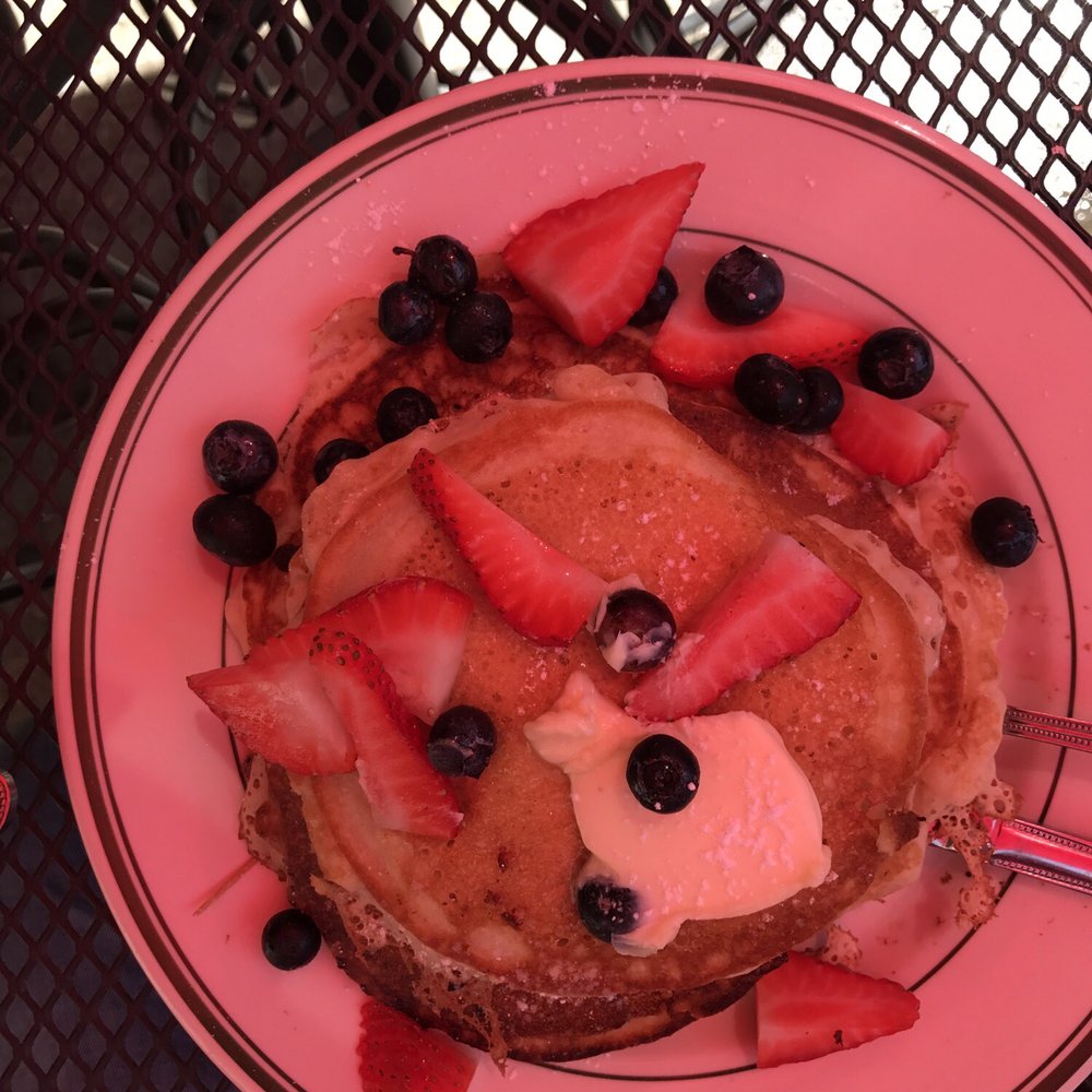 Amy's Place - Sorry for the red tint. It's the umbrella overhead. These chocolate chip banana pancakes rocked. - Sandwiches Near Me - Providence, Rhode Island