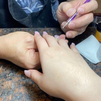 Artisan Nail & Spa - Him attempting to draw clouds - Nail Salons Near Me - Houston, Texas