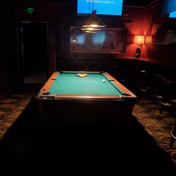 Kon Tiki - a pool table in a dimly lit room - Tiki Bars Near Me - Post Falls, Idaho Kon Tiki - a pool table in a dimly lit room - Tiki Bars Near Me - Post Falls, Idaho