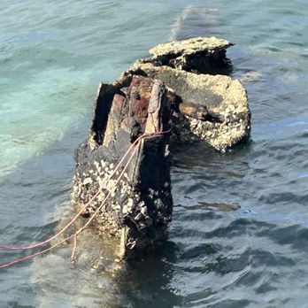 USS Arizona Memorial Programs - A piece of the USS Arizona still lodged in the water as a permanent underwater and above water memorial - Landmarks & Historical Buildings Near Me - Honolulu, Hawaii