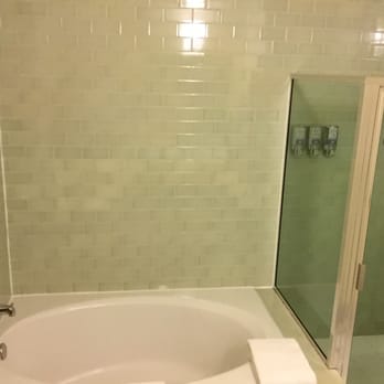 Acqua Hotel - Beautiful tile bathroom with stall shower, shampoo, conditioner, and shower gel mounted on the wall, plus an oversized tub. - Hotels Near Me - Mill Valley, California Acqua Hotel - Beautiful tile bathroom with stall shower, shampoo, conditioner, and shower gel mounted on the wall, plus an oversized tub. - Hotels Near Me - Mill Valley, California