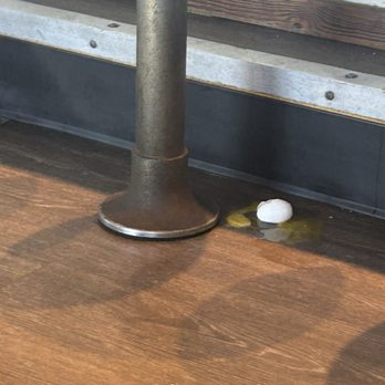 Breakfast Club - Broken raw egg on the floor by our table - Breakfast & Brunch Near Me - Tybee Island, Georgia