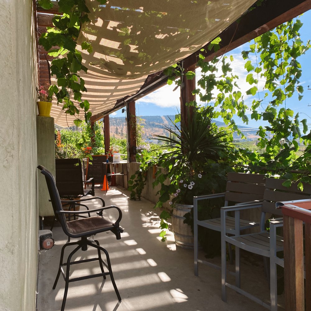 Black Widow Winery - a patio with a table and chairs - Wineries Near Me - Penticton, British Columbia