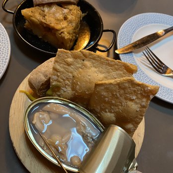 MariPili Tapas Bar - tortilla de patata in the back, navajas (clams) in the front - Spanish Near Me - Seattle, Washington MariPili Tapas Bar - tortilla de patata in the back, navajas (clams) in the front - Spanish Near Me - Seattle, Washington