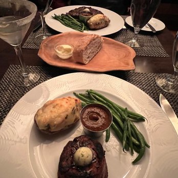 Truffles - Filet and Ribeye both with green beans and twice baked potatoes, bread in center of table, wine and lemon drop martini - American Near Me - St. Louis, Missouri Truffles - Filet and Ribeye both with green beans and twice baked potatoes, bread in center of table, wine and lemon drop martini - American Near Me - St. Louis, Missouri