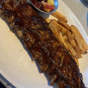 Firebirds Wood Fired Grill - Baby Back Ribs with steak fries and fresh fruit - Steakhouses Near Me - Gilbert, Arizona