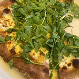 5 cheese pizza with arugula on wheat crust. 5 cheese pizza with arugula on wheat crust.
