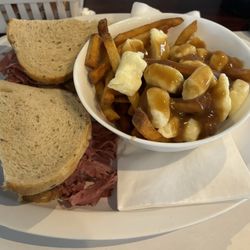 Frenchie's Bar & Grill - 8 oz. Montreal Smoked Meat Sandwich with a small poutine