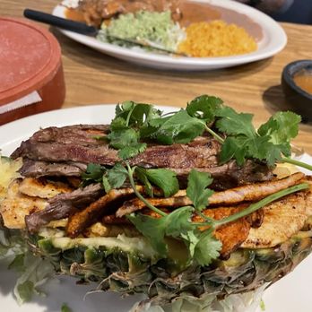 Chakas Mexican Restaurant - It was a pineapple filled with steak, chicken and pork. It had pieces of pineapple, grilled onions, other veggies. - Mexican Near Me - Denver, Colorado