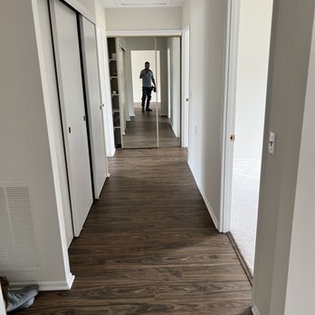 Carey’s Flooring and More - a person walking down a hallway - Flooring Near Me Carey’s Flooring and More - a person walking down a hallway - Flooring Near Me