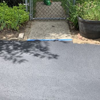 Williams Paving - a driveway with a gate and potted plants - Masonry/Concrete Near Me Williams Paving - a driveway with a gate and potted plants - Masonry/Concrete Near Me