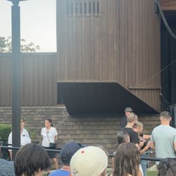 Employees guarding standing room only and the security guard on the left of the stage in the gray hat