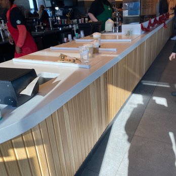 Starbucks - a man standing at a counter in a coffee shop - Coffee & Tea Near Me - Springfield, Missouri