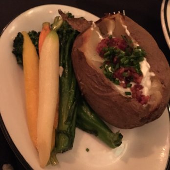 The Magic Castle - Baked potato and broccolini with carrots are sides that came with the Tomahawk steak - Performing Arts Near Me - Hollywood, California The Magic Castle - Baked potato and broccolini with carrots are sides that came with the Tomahawk steak - Performing Arts Near Me - Hollywood, California