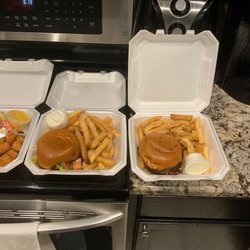 Smash burger on the left and regular burger with cheese and bacon added
