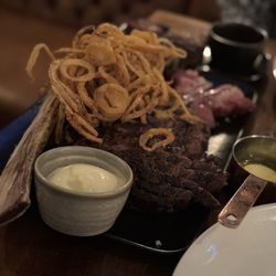 Tomahawk Steakhouse - 30oz Tomahawk for 2 with side of onion strings and blue cheese dip and Roasted Garlic and Thyme Butter