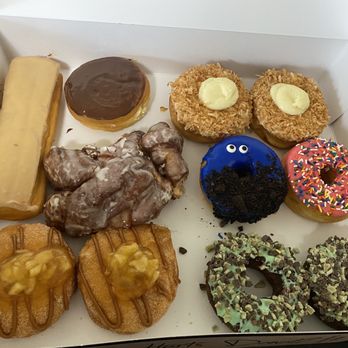 Hurts Donut - Maple long John, Bavarian cream, coconut cream, half eaten apple fritter, Cookie Monster, Homer, caramel apple, Andes mint - Donuts Near Me - Branson, Missouri Hurts Donut - Maple long John, Bavarian cream, coconut cream, half eaten apple fritter, Cookie Monster, Homer, caramel apple, Andes mint - Donuts Near Me - Branson, Missouri