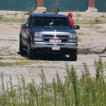 Marks Hauling - Mark J. White dumping branches in a business parking lot - Junk Removal & Hauling Near Me Marks Hauling - Mark J. White dumping branches in a business parking lot - Junk Removal & Hauling Near Me