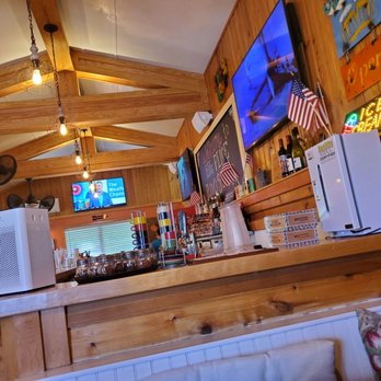 Big Pine Rooster - a bar with televisions and a couch - American Near Me - Big Pine Key, Florida Big Pine Rooster - a bar with televisions and a couch - American Near Me - Big Pine Key, Florida