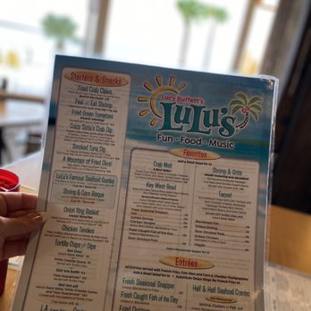 LuLu's Destin - a person holding a menu - Seafood Near Me - Destin, Florida
