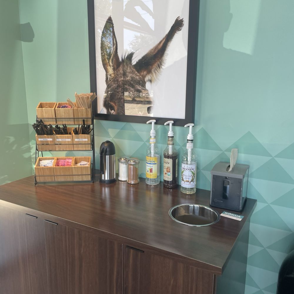 "Condiment" station or self serve station. Notice the syrup bottles there. They also have a sugar free option. "Condiment" station or self serve station. Notice the syrup bottles there. They also have a sugar free option.