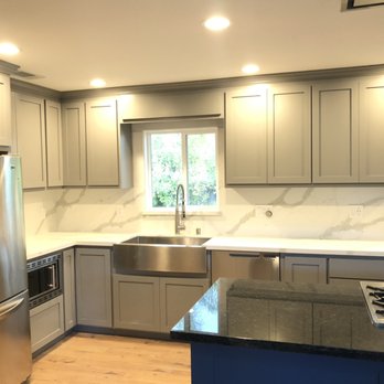 De Loza Construction - a kitchen with stainless steel appliances - General Contractors Near Me
